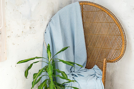 vintage ancient wooden chair with blue plaid knitted for the cover on a light wooden background, an Abstract Photo by YuMyart