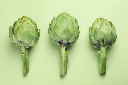 Concept of healthy food with artichoke on green background, a Food & Drink Photo by AtlasStudio PRO