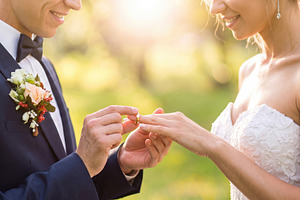 Groom Placing Wedding Ring on Bride Outdoors, a Person Photo by Davizro's Market