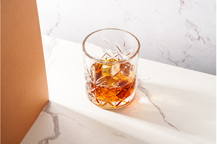 Whiskey with ice cube in the glass