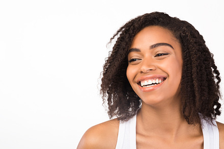 Close up portrait of laughing afro woman, a Person Photo by Prostock-Studio
