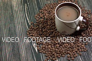 Cup Of Coffee And Grains On Table On Dark Background, Fragrant Hot Drink