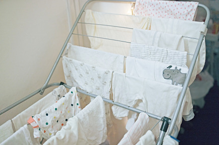 Baby's clothes, bodysuits and pants are dried after the laundry. Organization a, an Industrial Photo by TanaCh