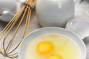 Fresh eggs, milk, and a whisk ready for cooking, a Food & Drink Photo by Olena Rudo