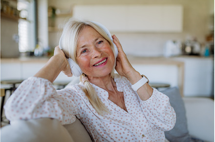 Senior woman with headphones, a Person Photo by HalfPoint