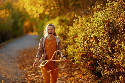 smiling elegant woman in fitness clothes in park, a Sports & Recreation Photo by Alliance Images