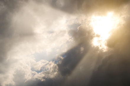 Sunbeams through storm clouds.