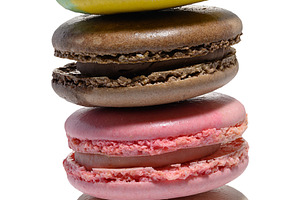 A vertical stack of four colorful macarons blue, yellow, brown,, a Food & Drink Photo by ndanko
