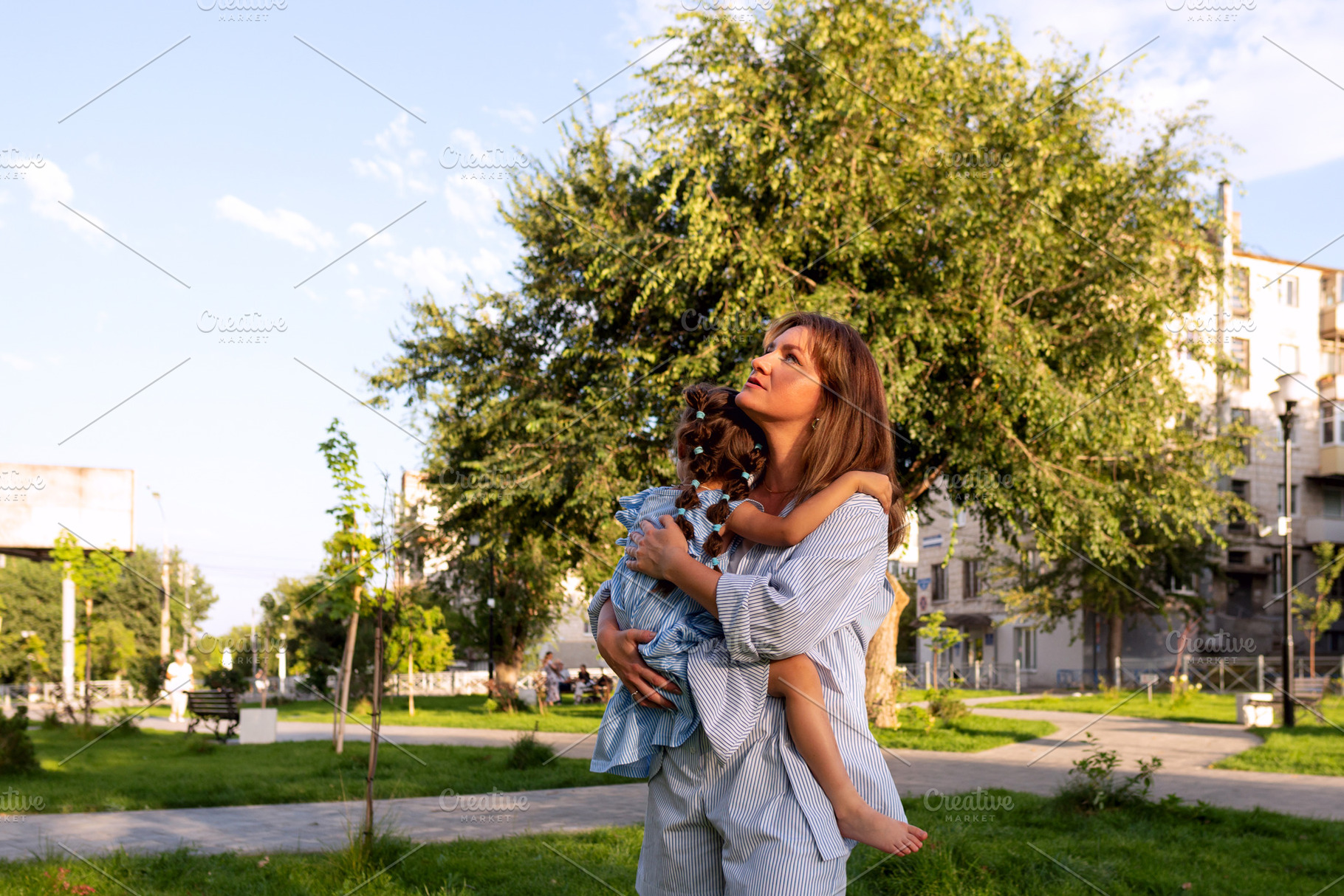 Mother gazes upward while cradling, a Person Photo by Elena Vagengeim