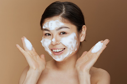 Portrait of young woman washing face, a Person Photo by Alliance Images