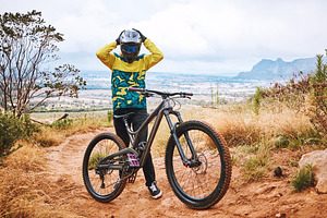 Mountain cyclist, bike and sports person on a outdoor nature road for a ride or sport race. Bicycle, fitness and workout training of an outdoors adventure athlete on a the mountains and dirt path, a Photo by Peopleimages.com