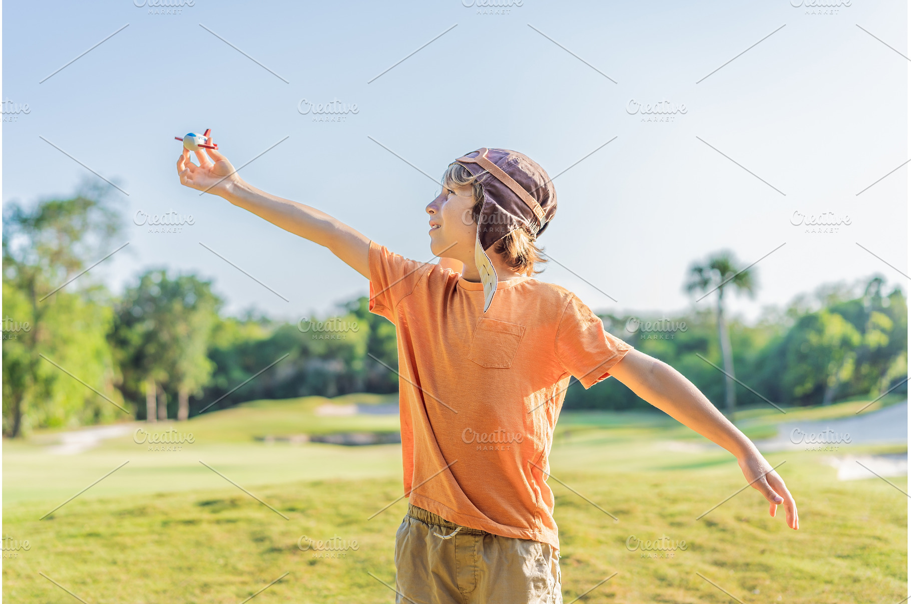 Boy wearing a pilot hat running, a Nature Photo by Elizaveta Galitskaya