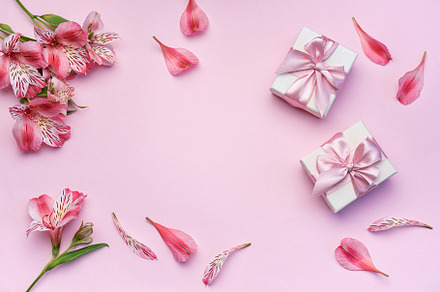 Beautiful Alstroemeria flowers and gift boxes on pink background, a Holiday Photo by Olena Rudo