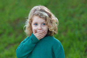 Surprised blond child covering his m stock photo containing child and cute, a School & Education Photo by José Manuel Gelpi