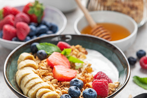 Delicious granola with yogurt, banana, and berries creating a nu, a Food & Drink Photo by Olena Rudo