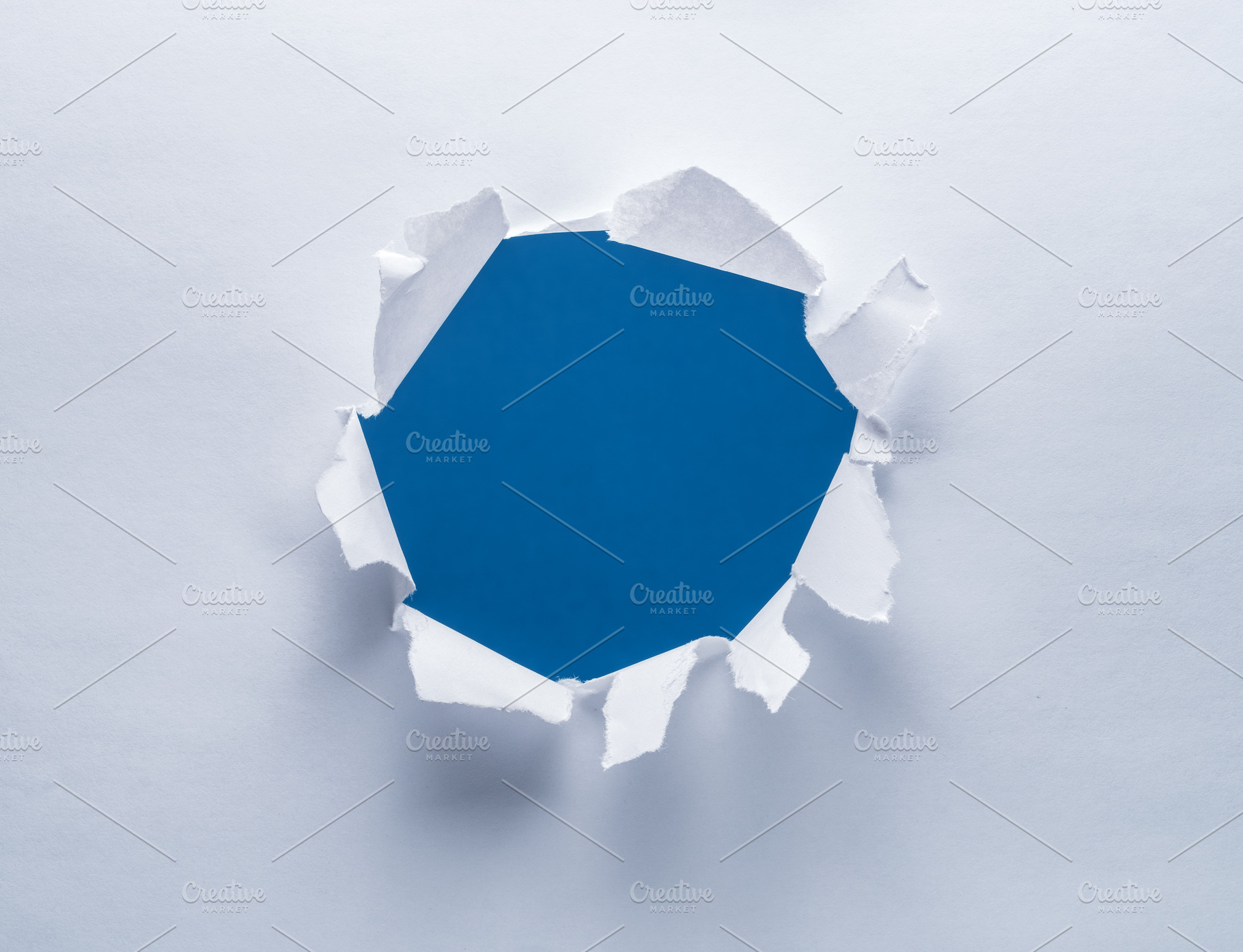 Hole on a paper. Blue background in the hole., a Background Photo by Volff