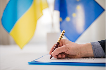 Signing document between European, a Business Photo by HalfPoint