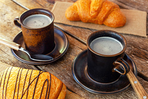 Enjoying italian breakfast with coffee and pastries on wooden table, a Food & Drink Photo by Antonio Gravante Market