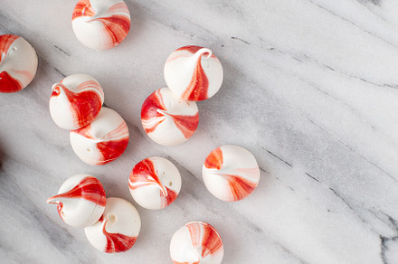 Peppermint meringues on a marble table, Christmas background
