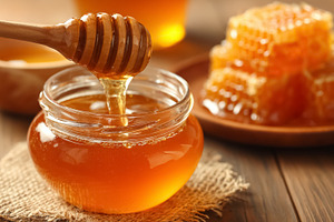 Honey dipper pouring golden natural and organic honey into a gla, a Photo by Studio ANNA
