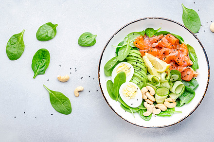 Keto salad bowl with salmon, avocado, spinach, cucumber, eggs, c, a Food & Drink Photo by 5PH