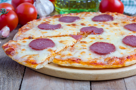 Homemade pepperoni pizza on a wooden board, ready to eat, a Food & Drink Photo by iuliia_n