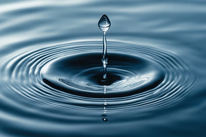 Droplet creates ripples of calm, a Photo by Pavel_design
