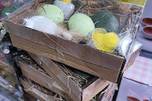Decorative Easter eggs in packaging placed on a festive display table, a Photo by AS photostudio