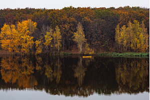 Yellow kayak on a calm lake, a Nature Photo by Red Hot Chili Pepper Shop