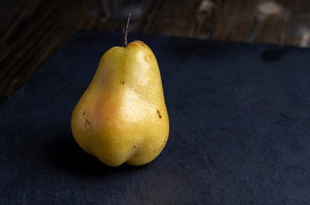 ripe green and yellow pear on a board, a Photo by MyPhotos