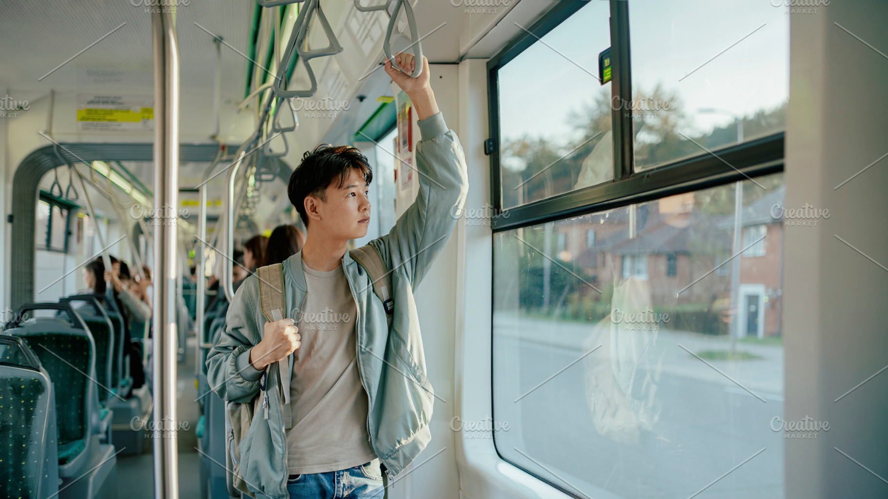 Asian teenager riding public transportation in city, a Person Photo by DanFLCreativo