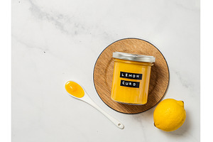 Homemade lemon curd in jar, top view, a Food & Drink Photo by Fascinadora