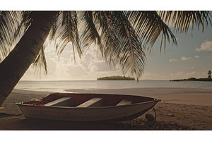 Boat resting on a tropical beach at, a Nature Photo by Goinyk