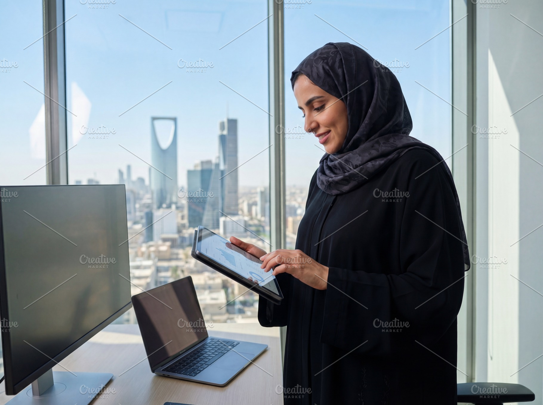 Saudi Businesswoman Working in a Mod, a Business Photo by Taiffco