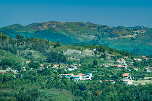 Mountain village with clustered homes among trees, a Transportation Photo by DanFLCreativo