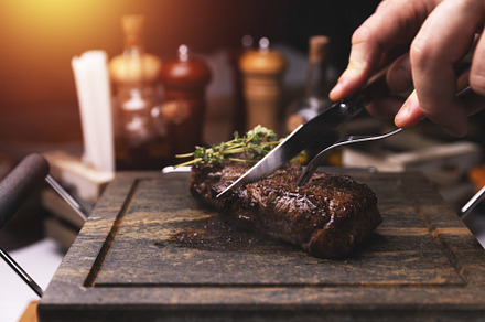Chef cutting grilled steak, a Photo by Grafvision photography