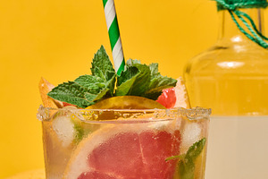 A clear glass with a cold drink, grapefruit slices, ice and mint, a Food & Drink Photo by ndanko