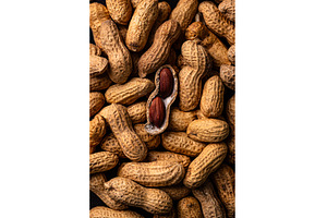 Pile of peanuts with one shell open, a Food & Drink Photo by Yulia Furman