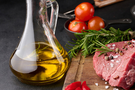 Raw piece of beef with spices pepper, rosemary sprig, salt and o, a Food & Drink Photo by ndanko