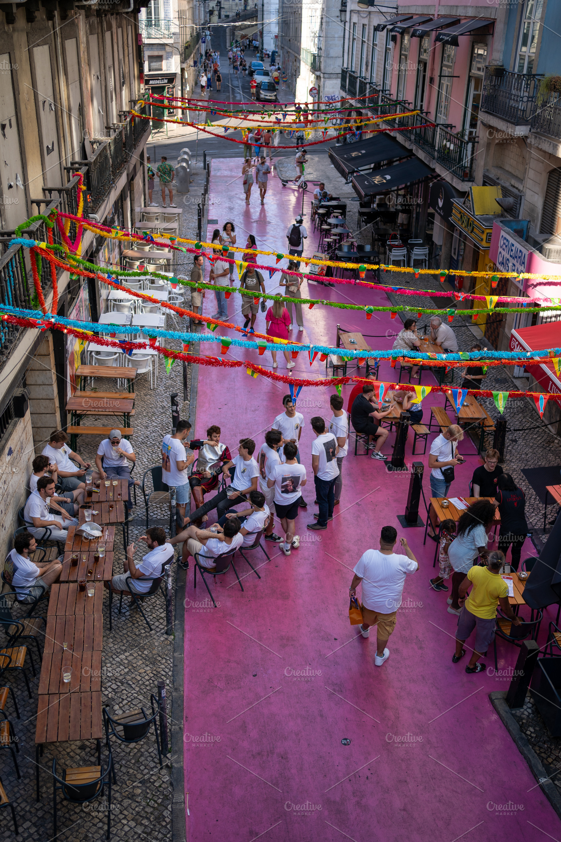 People at gay pride parade on famous decorated Pink Street in Lisbon, a Photo by andreonegin market