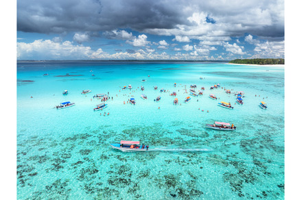 Aerial view of boats in clear azure, a Nature Photo by den-belitsky