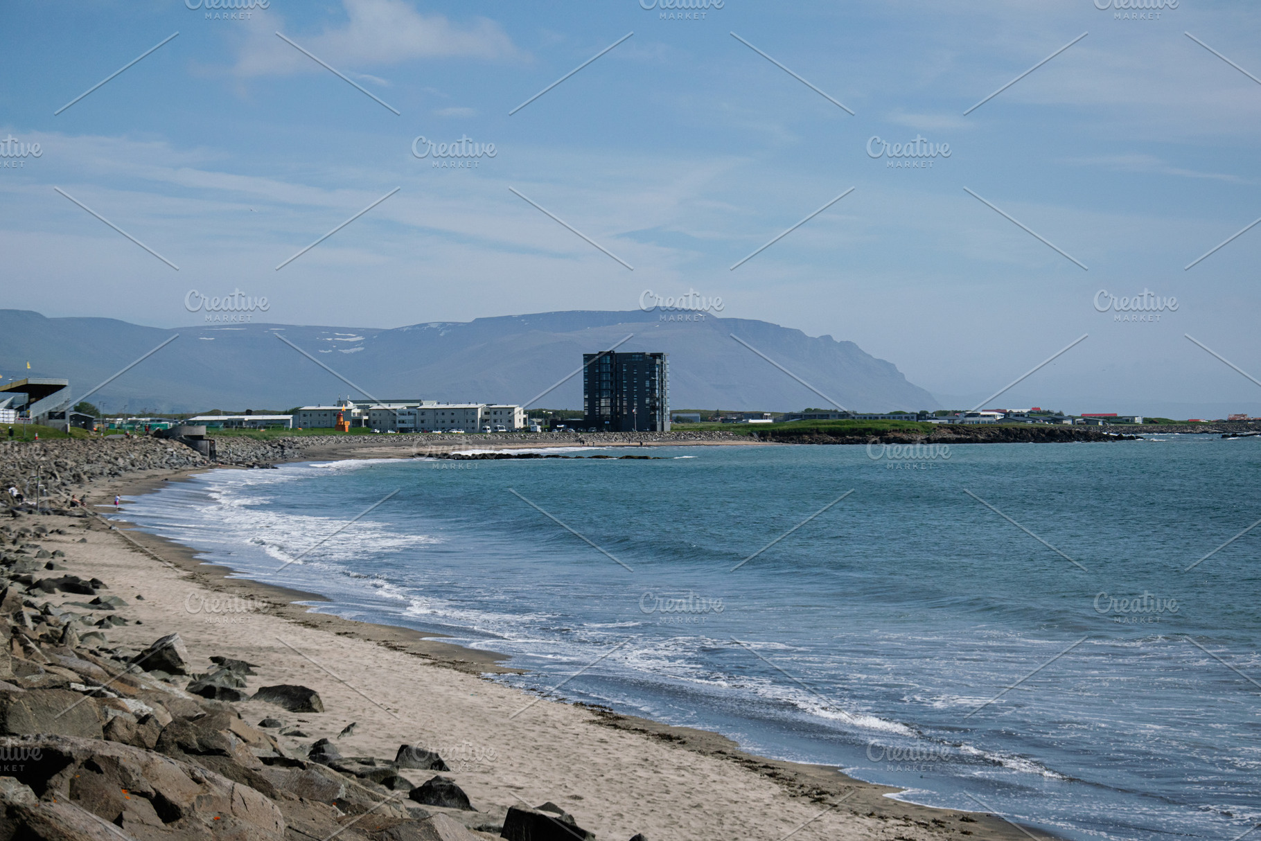Coastal view of Akranes, Iceland, with mountains and sandy beach shoreline, a Photo by AS photostudio