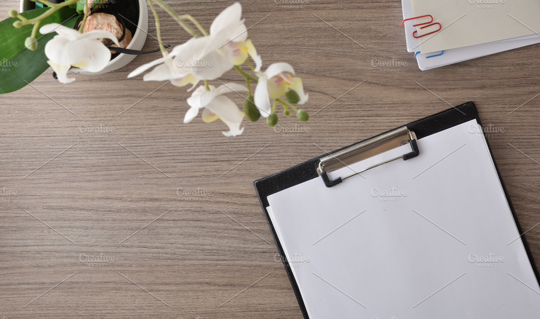 Clipboard and Orchid on Wooden Desk, a Business Photo by Davizro's Market