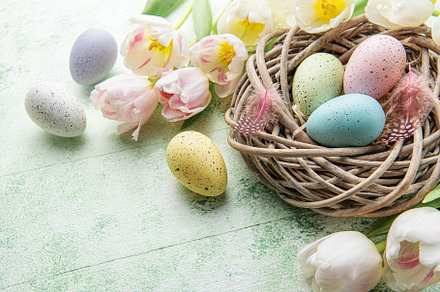Nest with Easter eggs painted pastel colors on a green wooden ba, a Holiday Photo by Olena Rudo