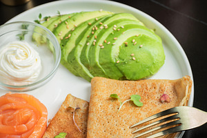 Roasted thin pancakes with smoked salmon and sauce, a Food & Drink Photo by Budarinphoto