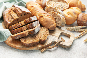 Assortment of fresh baked bread products and grains, a Food & Drink Photo by Olena Rudo
