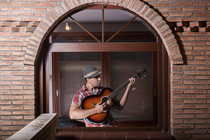Man playing guitar containing lifestyle, rhythm, and stage