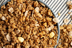 Healthy Homemade Toasted Muesli with Nuts in a Bowl, top view., a Food & Drink Photo by LiudmylaChuhunova