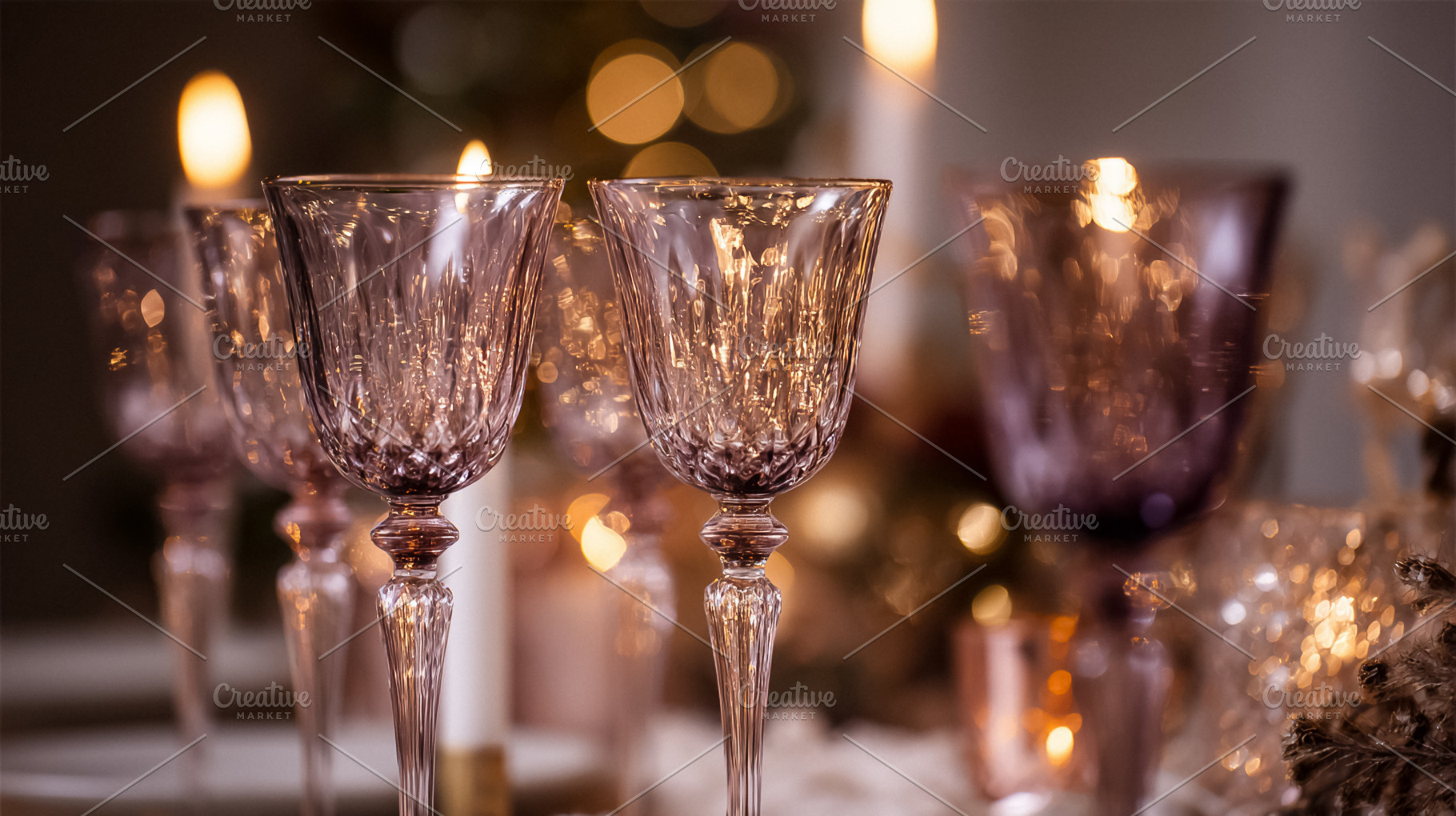Crystal wine glasses on a festive table setting with candlelight, a Photo by Studio ANNA