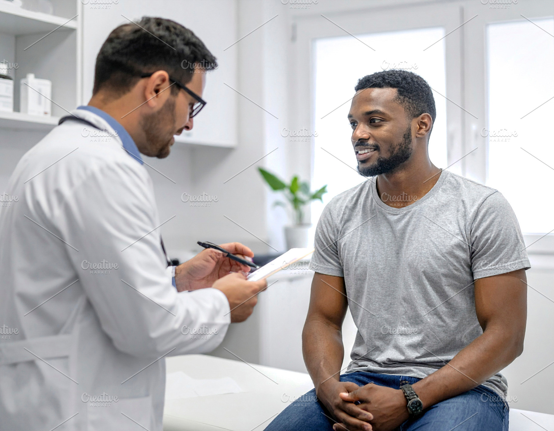 Black adult man patient sitting in a modern clinic being attende, a Health & Medical Photo by DanFLCreativo